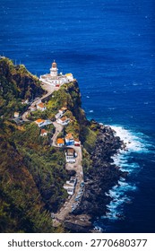 Dramatic view down to lighthouse on Ponta do Arnel, Nordeste, Sao Miguel Island, Azores, Portugal. Lighthouse Arnel near Nordeste on Sao Miguel Island, Azores, Portugal. 