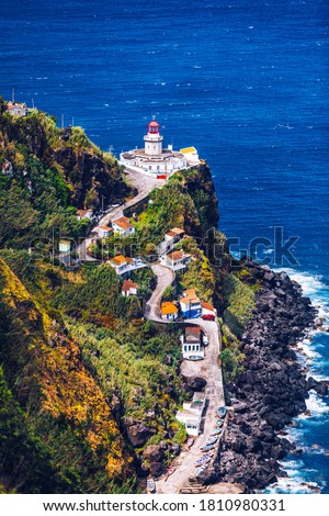 Dramatic view down to lighthouse on Ponta do Arnel, Nordeste, Sao Miguel Island, Azores, Portugal. Lighthouse Arnel near Nordeste on Sao Miguel Island, Azores, Portugal. 