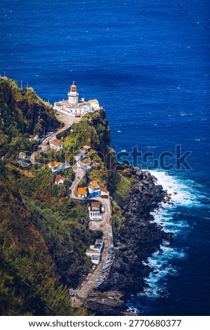Dramatic view down to lighthouse on Ponta do Arnel, Nordeste, Sao Miguel Island, Azores, Portugal. Lighthouse Arnel near Nordeste on Sao Miguel Island, Azores, Portugal. 