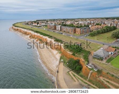 Dramatic view of the famous Jurassic cliffs of Hunstanton, Norfolk, UK. Showing the stripped iron and chalk cliffs. Showing heavy coastal erosion not too far from the apartments and houses.