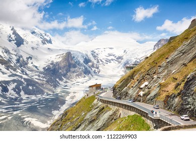 Dramatic view of the Grossglockner, seen from the Kaiser-Franz-Josefs-Höhe in the national wildpark in Tyrol, Austria. Partially snow covered mountains, shot against a partially clouded sky. 