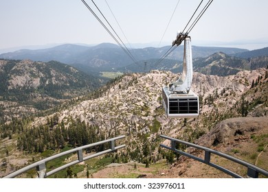 Dramatic View Of A Hanging Gondola.  The Tram Is Approaching The Mountain Top At Squaw Valley, A Western USA Ski Resort Seen Here In Summer.