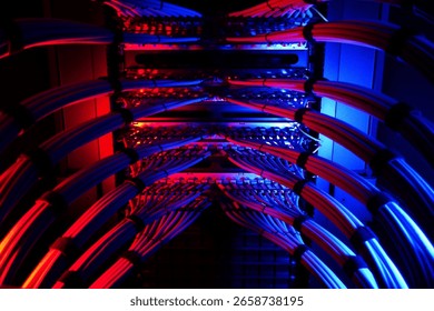 A dramatic view of illuminated network cables in a server room, showcasing vibrant blue and red lighting that enhances the technological ambiance. - Powered by Shutterstock - Get 15% off with code: PIKWIZARD15