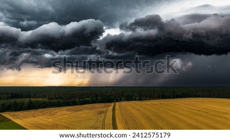 A dramatic view of an incoming storm over a vast expanse of plains, with dark clouds rolling