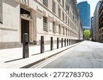 Dramatic view of a line of security bollards located outside a central London government building in Pimlico. The bollards act as perimeter security for unauthorised vehicles in the area.