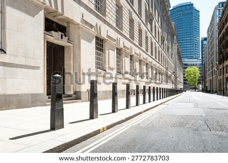 Dramatic view of a line of security bollards located outside a central London government building in Pimlico. The bollards act as perimeter security for unauthorised vehicles in the area.