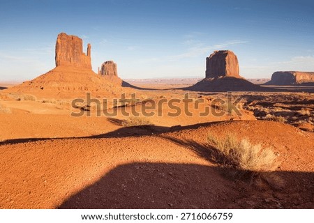 Dramatic view of the Monument Valley's magnificent butte and mittens lit up during a sunset.
Iconic butte, spire and mitten formations used as a backdrop in many old western movies. Navajo,Arizona.