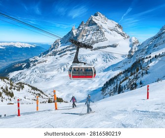 Dramatic view of Mount Titlis peak and glacier with cable car options in Engelberg, Switzerland. Perfect for alpine winter sports, snow adventure, and Swiss tourism concepts