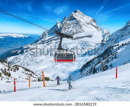Dramatic view of Mount Titlis peak and glacier with cable car options in Engelberg, Switzerland. Perfect for alpine winter sports, snow adventure, and Swiss tourism concepts