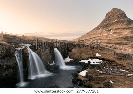Dramatic view on Kirkjufellsfoss waterfall  near Kirkjufell mountain at sunset.  Location: Kirkjufellsfoss, Grundarfjordurn, Iceland, Europe