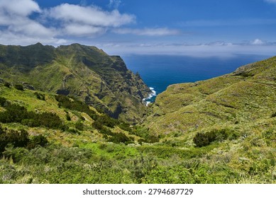 Dramatic view over the rugged volcanic cliffs and green slopes of Anaga dropping steeply into the Atlantic ocean, Tenerife