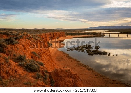Dramatic view of red cliffs and rail bridge over Spencer Gulf, Port Augusta (Kurdnatta), South Australia.    