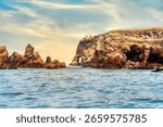 A dramatic view of the rugged coastal cliffs of the Ballestas Islands in Peru