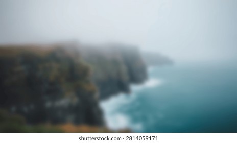 A dramatic view of rugged coastal cliffs shrouded in mist, with turquoise ocean waves crashing against the shore.