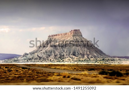 Dramatic view of a sandstone mountain called Factory Butte rock