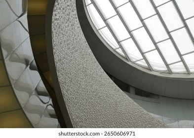 A dramatic view of the spiraling architecture and skylight roof of the central atrium in Porto Leixões Cruise Terminal, showcasing modern Portuguese design