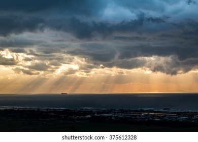 dramatic view of sunlight through the clouds over the see