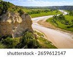 A dramatic view from Wind Canyon at Theodore Roosevelt National Park overlooks the winding Little Missouri River