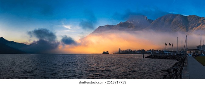 Dramatic wall of fog glowing against the light of the rising or setting sun over Lake Lucerne, Switzerland - Powered by Shutterstock