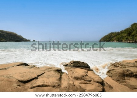 Dramatic waves crash onto wild coast, revealing the power of nature at this beach in Tobago. This wild coast beach showcases nature’s force. Ideal for beach ads, travel journals, or scenic tours.