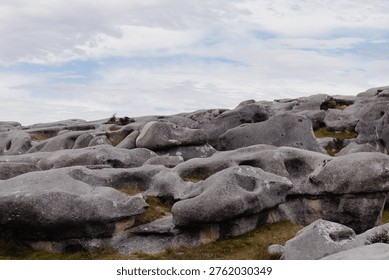 Dramatic Weathered Limestone Rock Formations Under Overcast Blue Sky