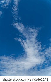 Dramatic White Cloud Formation Against Deep Blue Sky Background