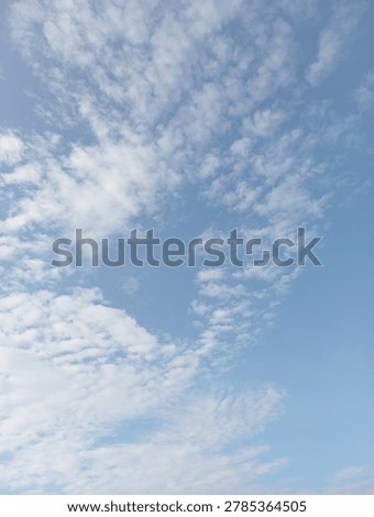 Dramatic white clouds against bright blue sky ,creating a peaceful and natural outdoor atmosphere.