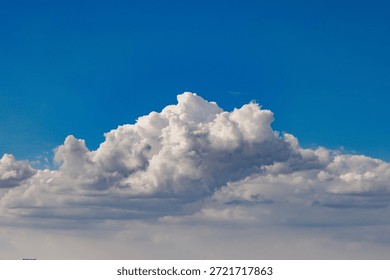 Dramatic White and Grey Cumulus Clouds Against Bright Blue Sky