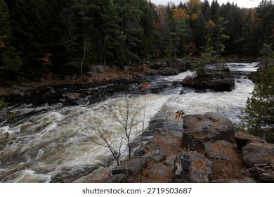 dramatic white water rapids cascading river ancient river stones in the  in the Parc Des Chutes Dorwin - Rawdon