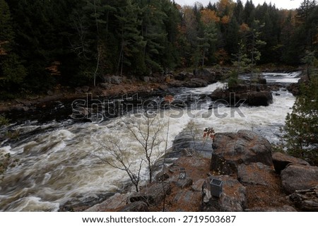 dramatic white water rapids cascading river ancient river stones in the  in the Parc Des Chutes Dorwin - Rawdon