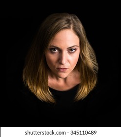 Dramatic woman looking at the camera surrounded by black