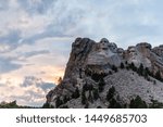 A dramatically colorful sky developing around sunset behind the four US presidents of Mount Rushmore, in North Dakota.