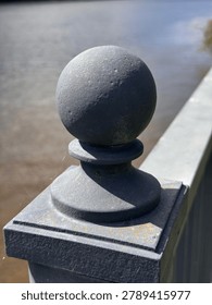 Dramatically lit gray railing finial