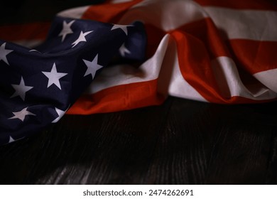 Draped American Flag on Dark Wooden Surface, Symbolizing Patriotism and National Pride - Powered by Shutterstock