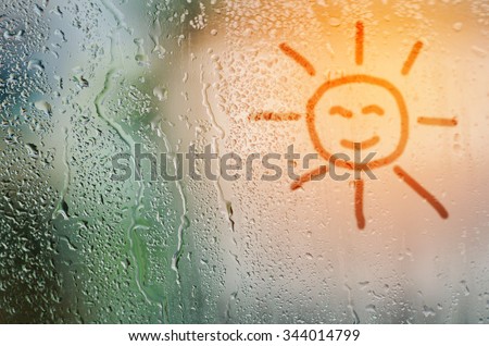 draw sun on natural water drops glass window background