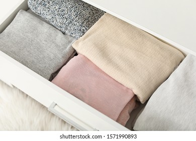 Drawer With Stacked Clean Clothes In Dressing Room