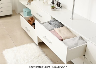 Drawers with clean clothes in dressing room