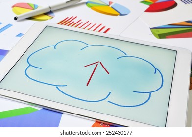 A Drawing Of A Cloud With An Arrow Inside On The Screen Of A Tablet, Depicting The Concept Of Upload To The Cloud Storage