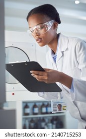 Drawing Conclusions From Her Observations. Shot Of A Young Scientist Working In A Lab.