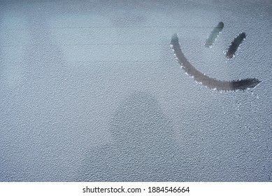 Drawing emoticon on a snowy car window
