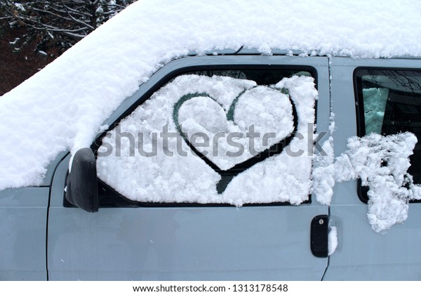 Drawing a heart in the snow on a car window is a\
little sign of love and affection. This car is in Saint Andre\
street in Montreal between the Ville Marie neighborhood and the\
Plateau Mont Royal.