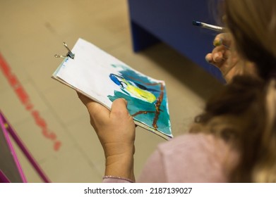 Drawing lesson. Teacher shows children how to draw picture of  blue tit with gouache - Shutterstock ID 2187139027