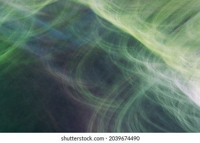 Drawing With Light, Depicting Rays, Circles, Thin Lines, Glare. Abstract Background In Shades Of Green. Photo Effect.