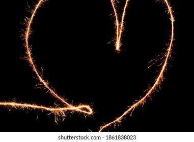 drawing with light at night on long exposure. spiral circles and wavy lines with the help of a pyrotechnic sparkler. black yellow white color effect hand movements - Powered by Shutterstock