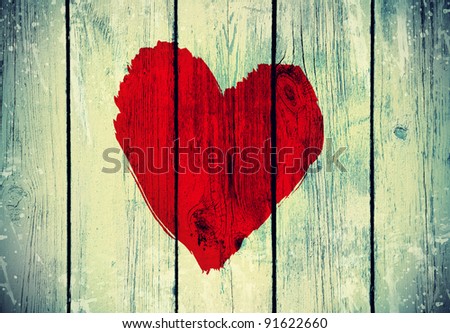 drawing love symbol on old wooden wall