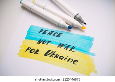 drawing with markers with the flag of Ukraine and the inscription peace, not war for Ukraine. High quality photo. Pray for Ukraine