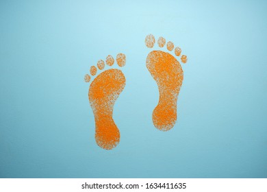  Drawing on a blue background. Orange human footprints