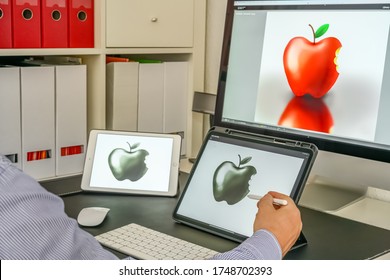 Drawing On The Tablet Computer. Digital Pencil In The Artist's Hand. Apple Drawing On A Tablet Computer.
