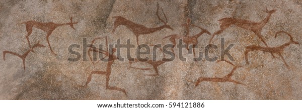 drawing on the wall in a cave, the rock. red\
ocher paint. Prehistoric man preys on animals deer. neanderthal,\
primitive, caveman, stone age, ice\
age.