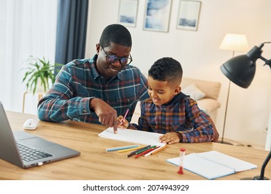 Drawing together. African american father with his young son at home. - Shutterstock ID 2074943929